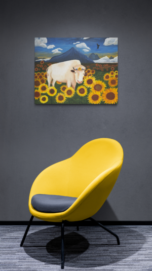 White buffalo and sunflower painting over yellow chair